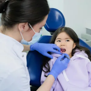 How a Pediatric Dentist in Garden City Prevents Childhood Cavities