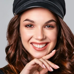 Smiling woman with bright, white teeth showcasing results of teeth whitening in Garden City, highlighting a confident and radiant smile